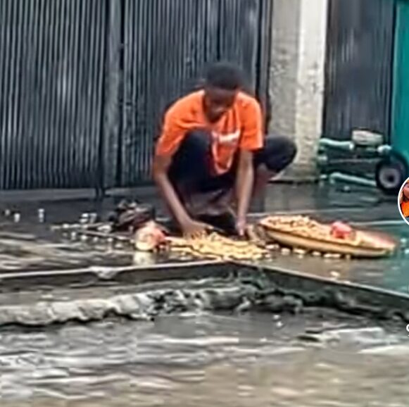 Heartbreaking moment as groundnut seller slips during heavy rain fall, goods scatter on ground